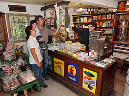 Salzburg Open Air Museum - family in the grocer's store in the Flachgau section