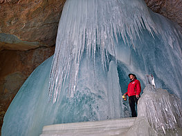 Eisriesenwelt Werfen Giant Ice Caves - A man with lantern on the ice in the cave