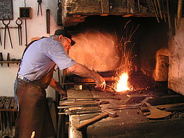 Salzburg Open Air Museum - man demonstrates blacksmith's craft