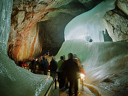 Eisriesenwelt Werfen Giant Ice Caves - group of visitors on the path through the ice inside the cave