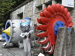 Kaprun Alpine Reservoirs - In front of the Verbund Info Center with mascot and exhibited water turbines