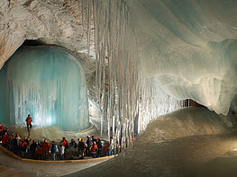 Eisriesenwelt Werfen Giant Ice Caves - group of visitors on the path through ice formations inside the cave