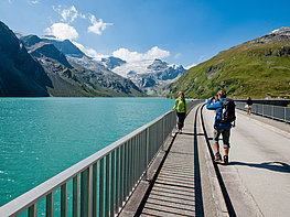 Kaprun Alpine Reservoirs - Couple taking photos on Mooserboden dam wall